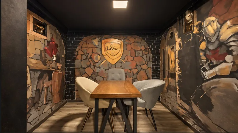 Games corner with stone and knight murals, a wooden table and three armchairs